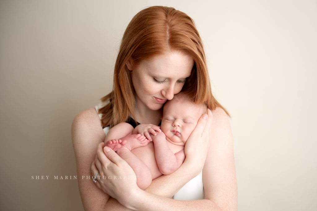 red head mother holding newborn baby boy