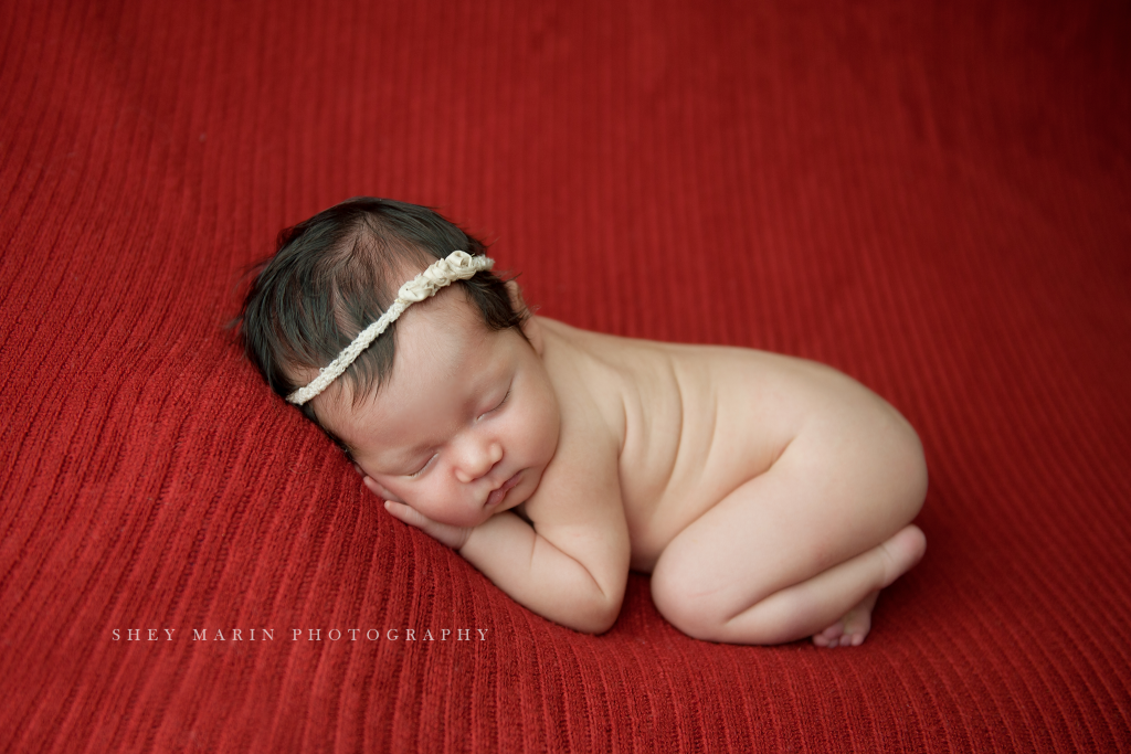 baby girl on red blanket bold color frederick maryland
