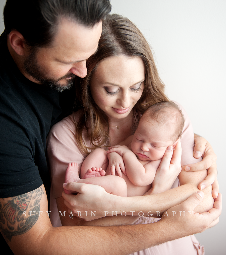 Frederick Maryland newborn baby photographer | nephew baby cuddled by parents