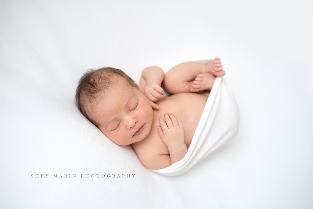 Frederick Maryland newborn baby photographer | nephew baby in white wrap blanket