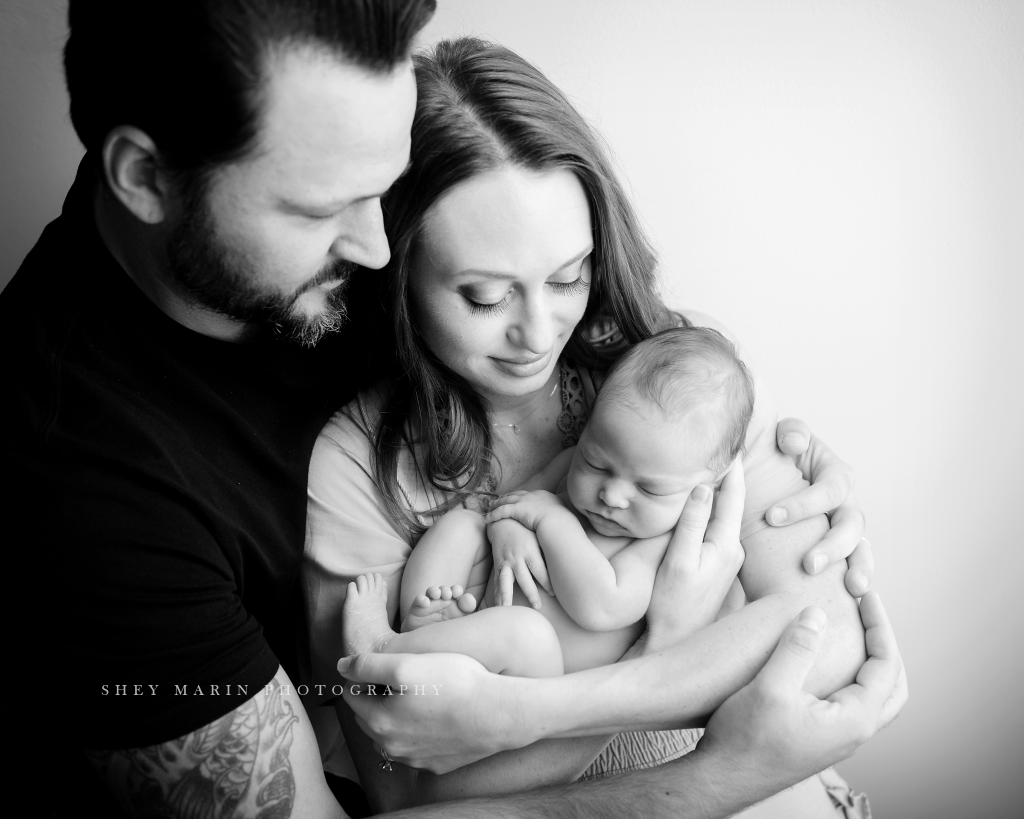 Frederick Maryland newborn baby photographer | nephew baby being held by parents