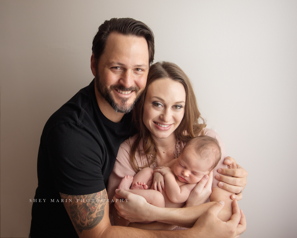 Frederick Maryland newborn baby photographer | nephew baby held by parents looking at camera