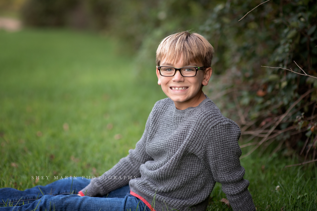 Frederick Maryland child with glasses photographed in meadow