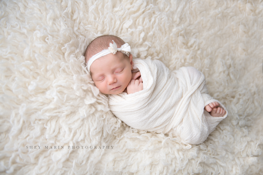 studio newborn on white fur | frederick maryland baby photographer