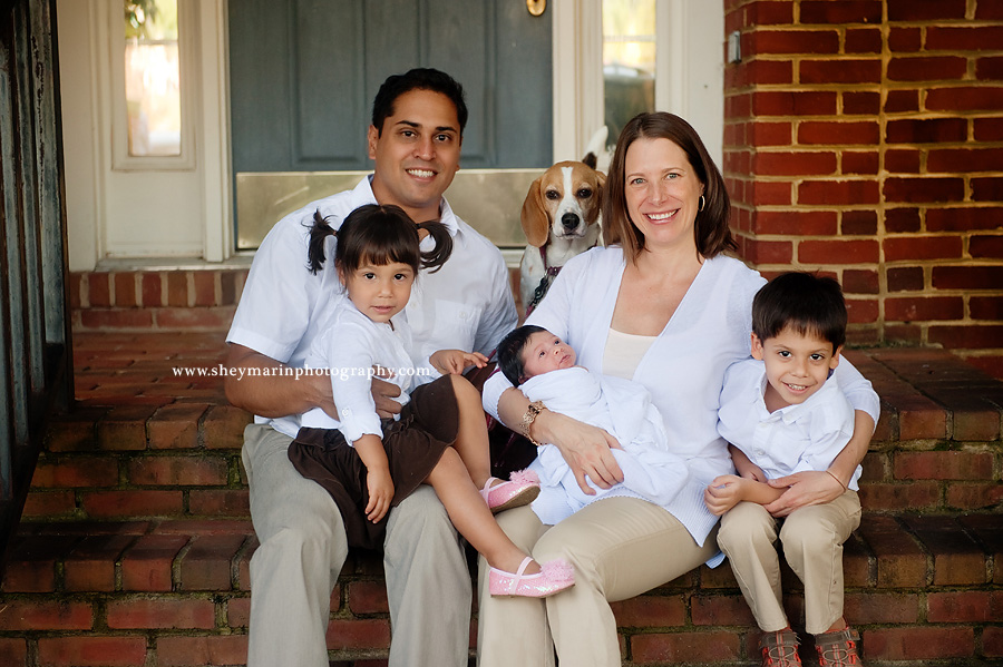 family on their front porch steps