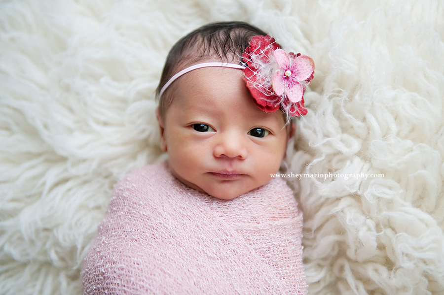 newborn baby girl wrapped in pink