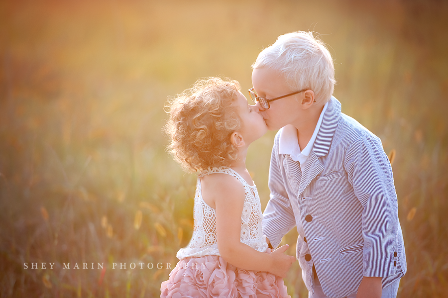 brother and sister giving a kiss