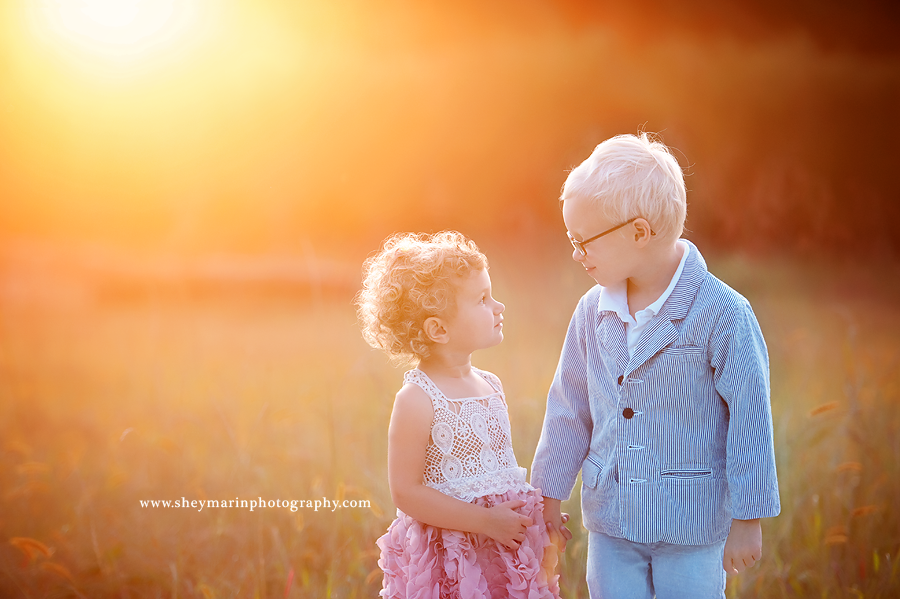 brother and sister looking at eachother at sunset