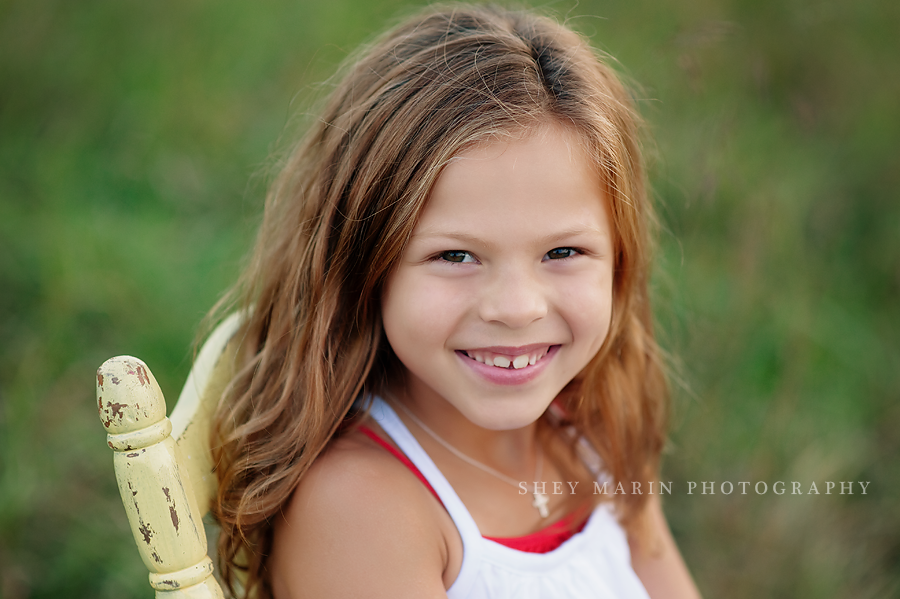 sweet girl smiling in chair