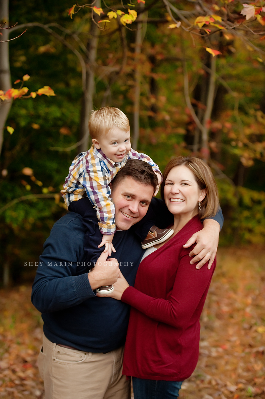 family playing in leaves