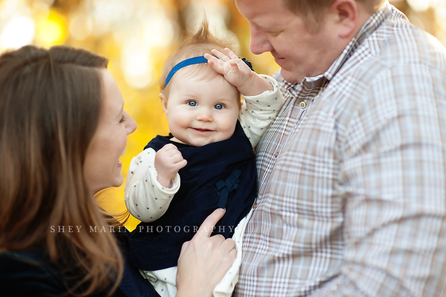 girl with mom and dad in fall