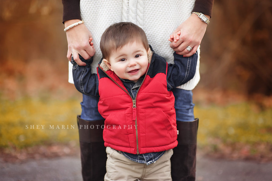 boy holding his mother's hands in Baker Park, Frederick Maryland