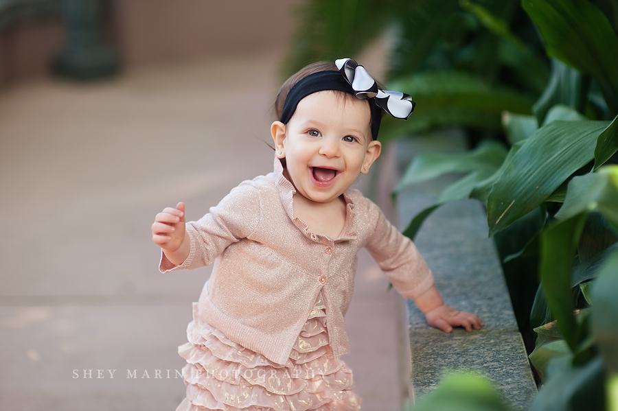 happy laughing one year old trying to walk