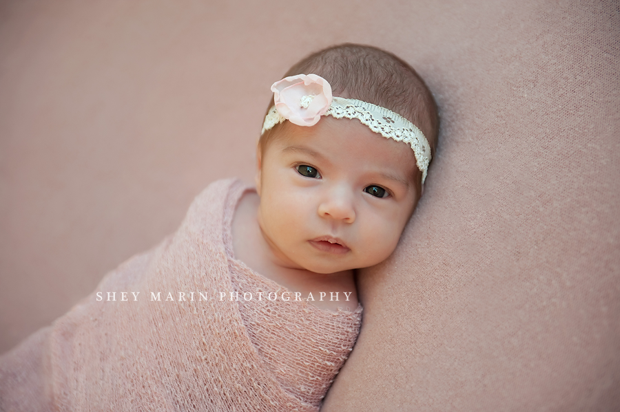 beautiful newborn girl looking at camera