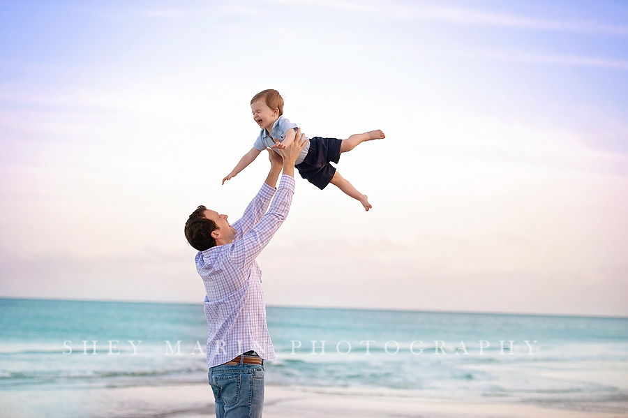 boy and dad playing at beach