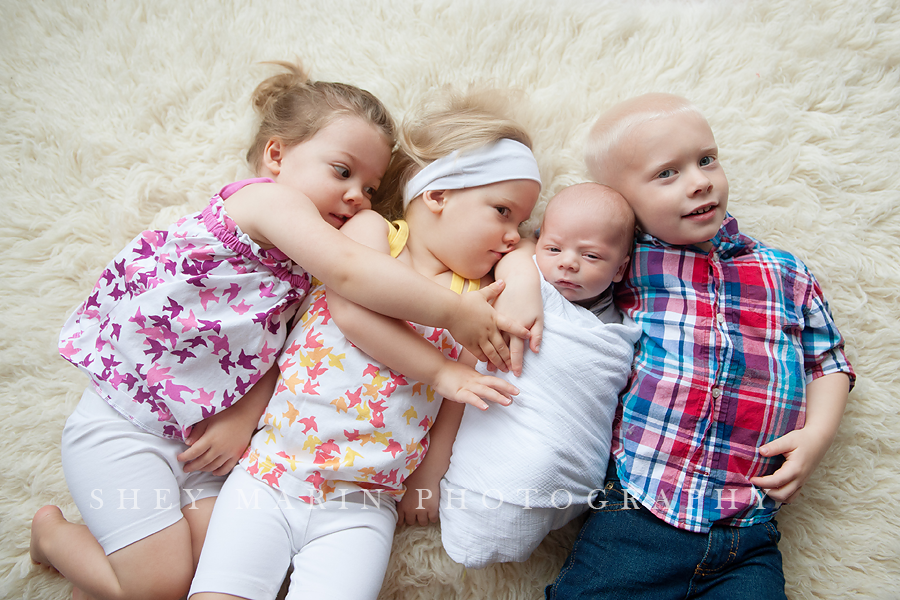 four siblings hugging