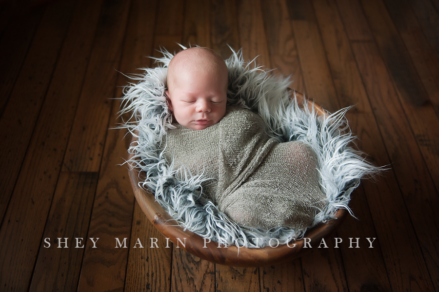 baby boy in wooden bowl prop