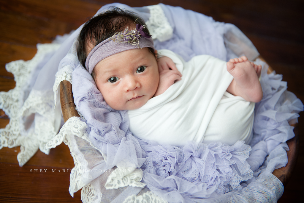 newborn baby girl in wood bowl awake in washington DC